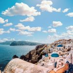 Captivating view of Santorini's famous blue-domed buildings under a vibrant sky.