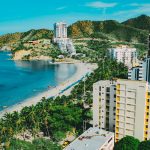 A breathtaking aerial view of Santa Marta's beachfront, showcasing a blend of nature and modern architecture.